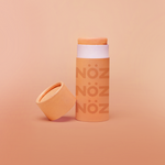 Load image into Gallery viewer, Front view cap off image of orange color noz sunscreen stick 
