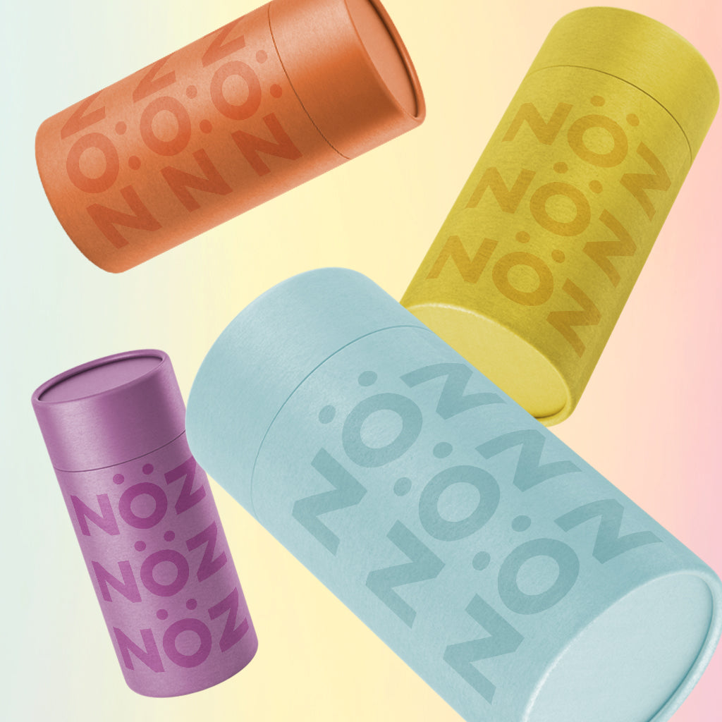 Floating image of orange, blue, purple, and yellow noz sunscreen stick 