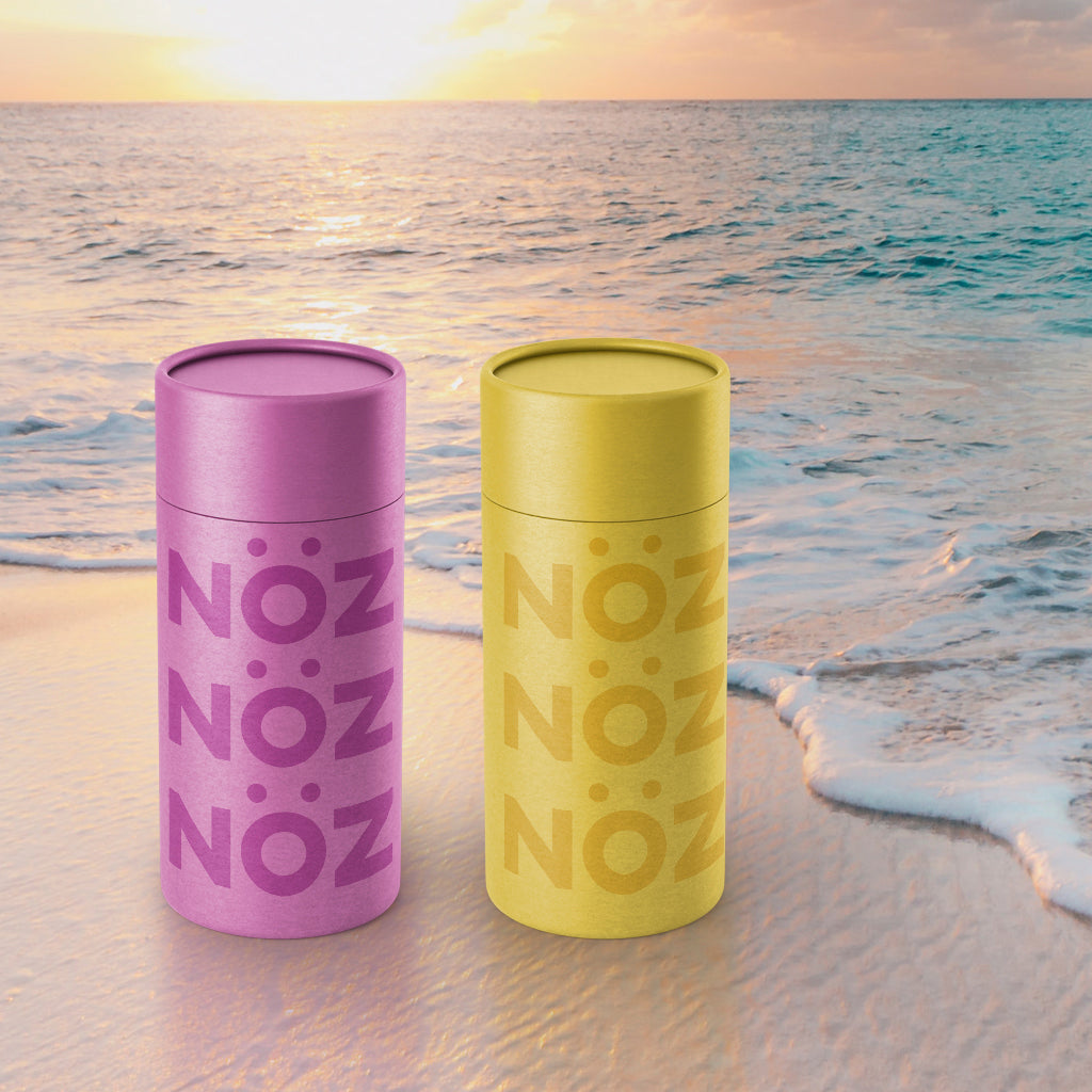 Purple and yellow noz sunscreen image against beach background